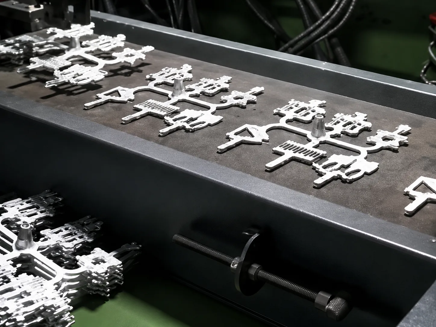Raw zinc alloy castings on a sprue, fresh from the mold