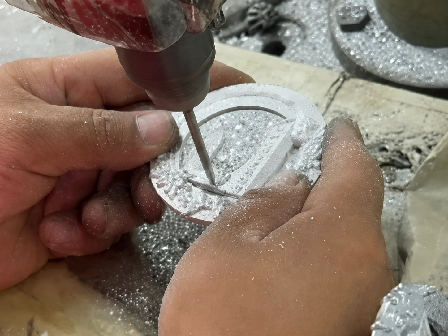 Manual finishing of a custom zinc alloy metal part before surface treatment