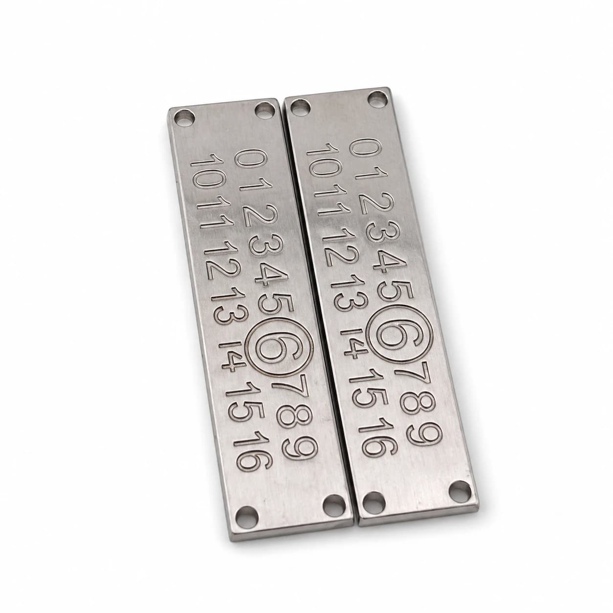 The back of a metal plate showing a pair of folding prongs