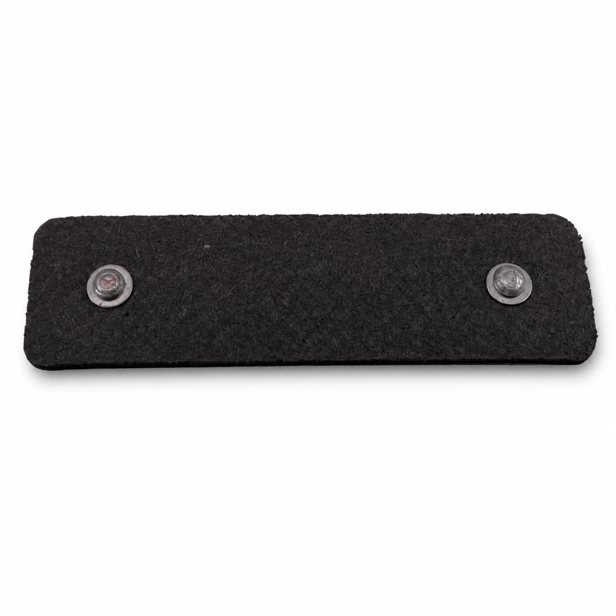 The back of a metal plate showing two rivet holes